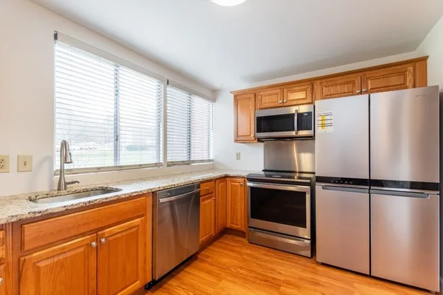 a kitchen with a sink stove and microwave