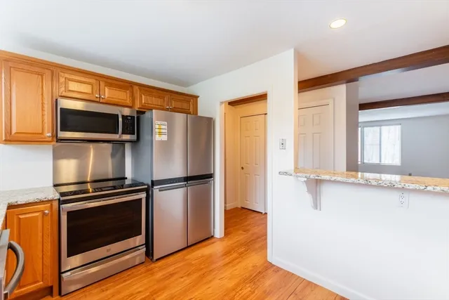 a kitchen with stainless steel appliances a stove a microwave and a refrigerator