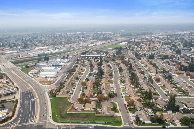 an aerial view of residential houses with city view