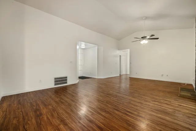 wooden floor in an empty room with a window