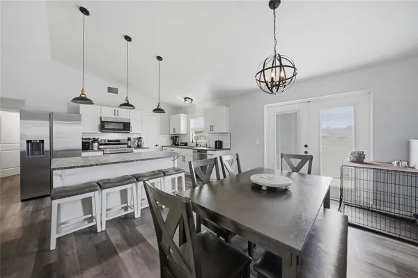 a view of kitchen and dining area with furniture wooden floor