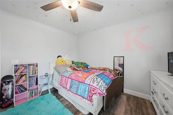 a bedroom with a bed and a tv