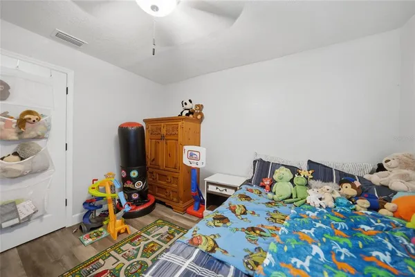 a bed room with furniture and a wooden floor