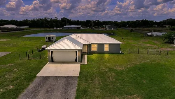a aerial view of a house with a yard