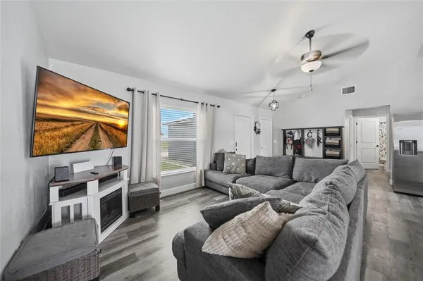 a living room with furniture and a flat screen tv