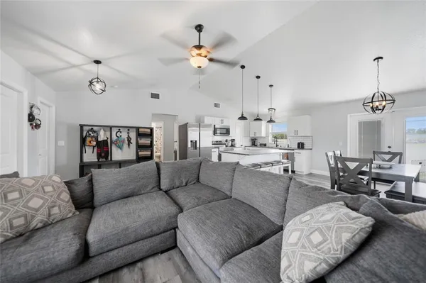 a living room with furniture and a chandelier