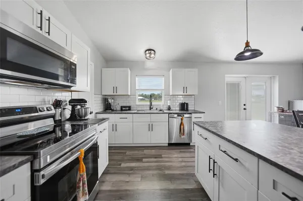 a kitchen with a sink stainless steel appliances and cabinets