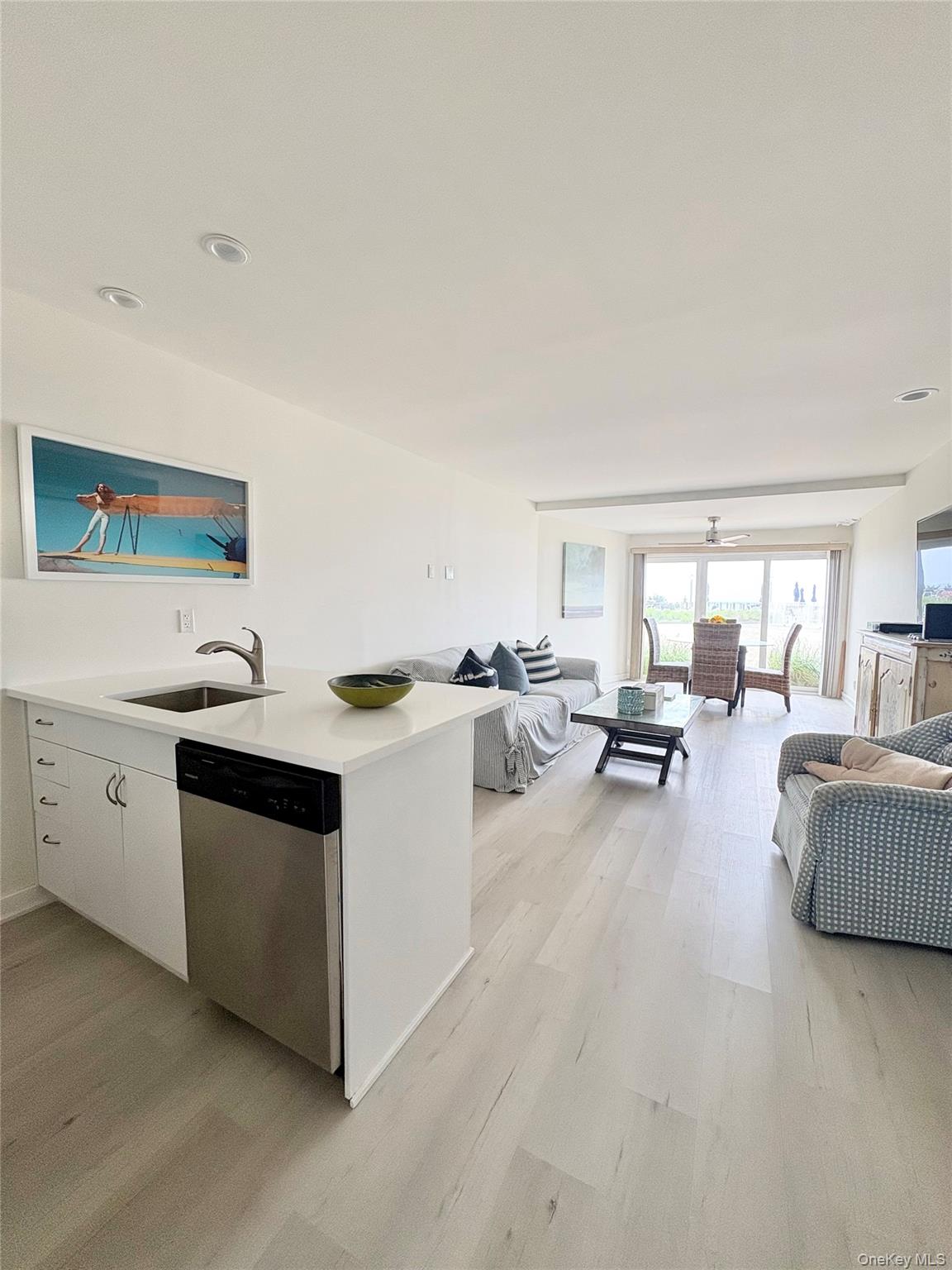 585 Dune Road, Unit A21 Westhampton Beach, NY 11978 - Photo 13 of 13 Open Floor Plan with Sliding Door Leading to the Pool and Beach!