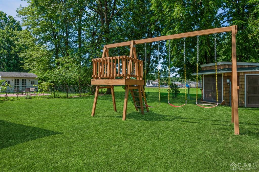 24 Markham Road Edison, NJ 08817 - Photo 18 of 20 a view of a chair and table on the green field