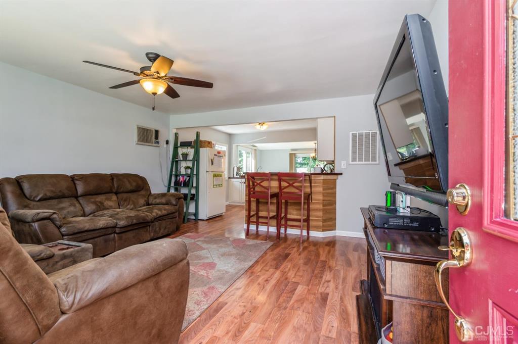 24 Markham Road Edison, NJ 08817 - Photo 19 of 20 a living room with furniture and a flat screen tv