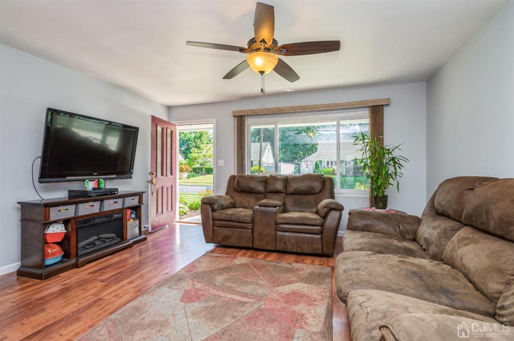 24 Markham Road Edison, NJ 08817 - Photo 4 of 20 a living room with furniture and a flat screen tv