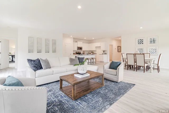 a living room with furniture wooden floor and a view of kitchen