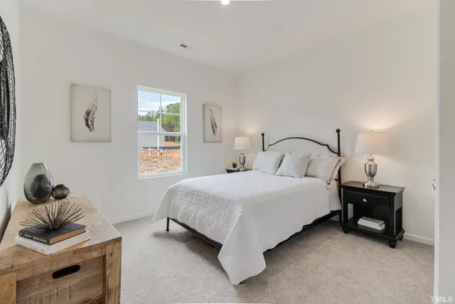 a bedroom with a bed and window