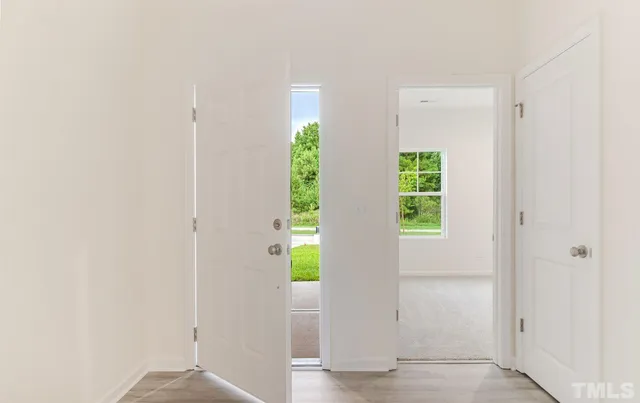 a view of an entryway with wooden floor