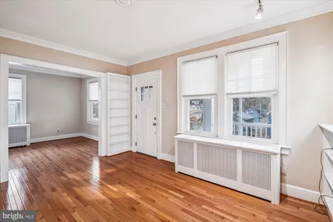 a view of a living room kitchen with a fireplace and windows