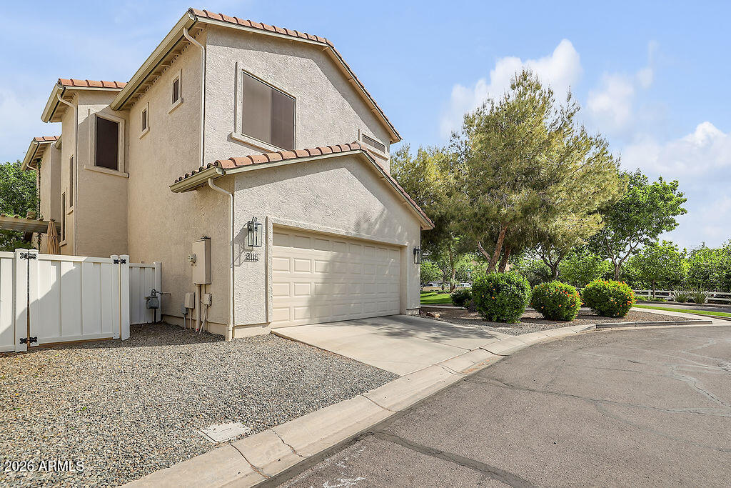 3116 East Tamarisk Street Gilbert, AZ 85296 - Photo 14 of 35 a front view of a house with a yard and garage