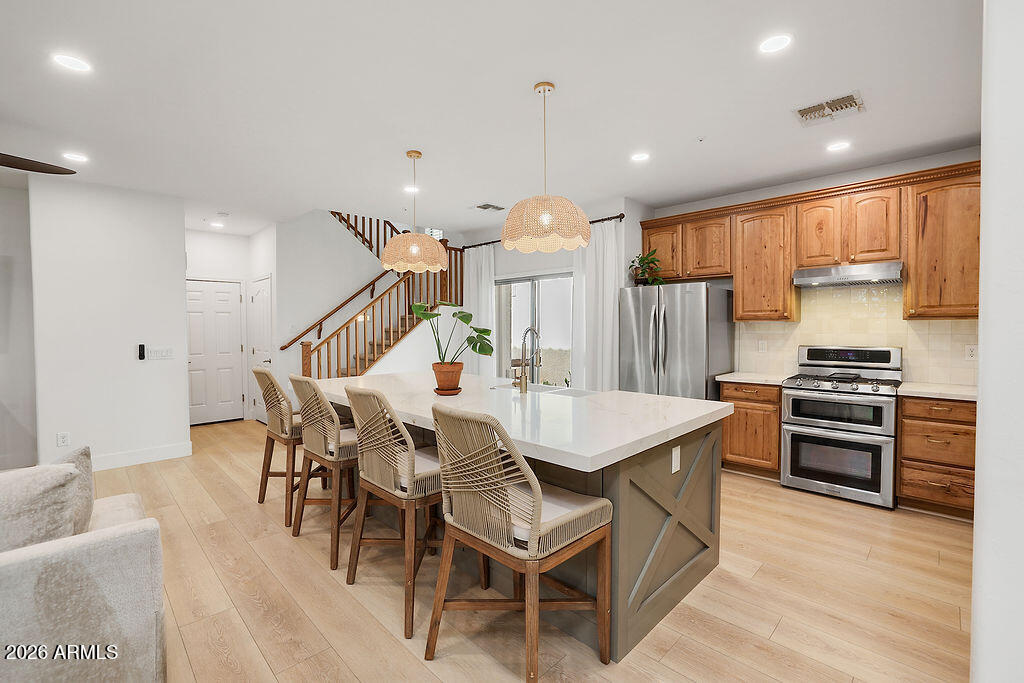 3116 East Tamarisk Street Gilbert, AZ 85296 - Photo 15 of 35 a dining room with furniture and wooden floor
