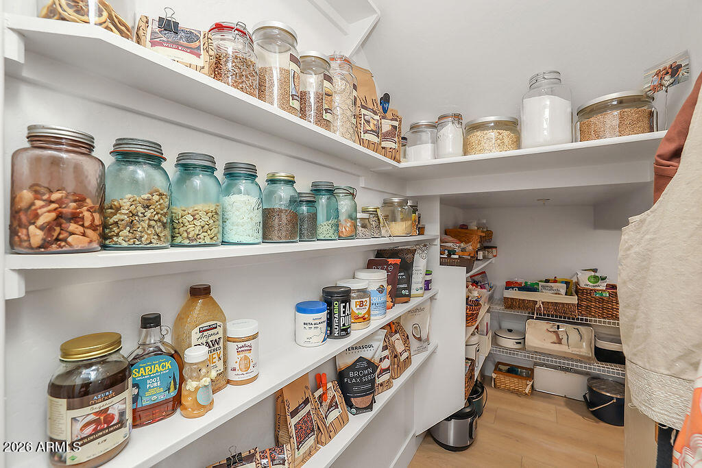 3116 East Tamarisk Street Gilbert, AZ 85296 - Photo 17 of 35 a kitchen with lots of clutter and cabinets