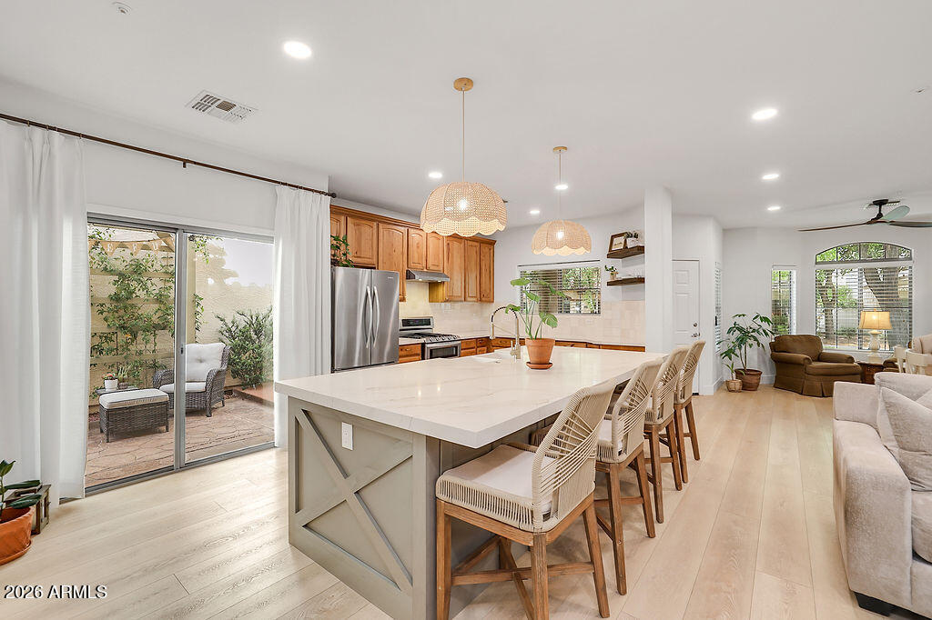 3116 East Tamarisk Street Gilbert, AZ 85296 - Photo 2 of 35 a large kitchen with a table and chairs