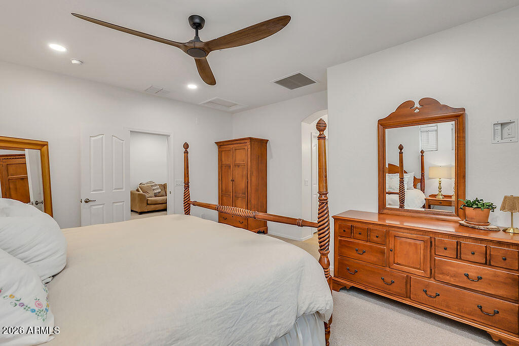 3116 East Tamarisk Street Gilbert, AZ 85296 - Photo 21 of 35 a bedroom with a bed a dresser and a large mirror