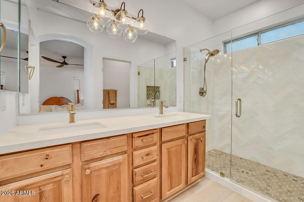 3116 East Tamarisk Street Gilbert, AZ 85296 - Photo 22 of 35 a bathroom with a double vanity sink a mirror a glass door a shower and vanity