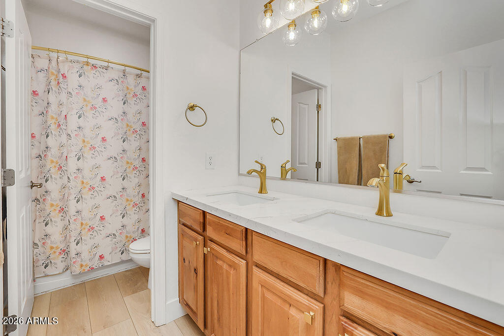 3116 East Tamarisk Street Gilbert, AZ 85296 - Photo 26 of 35 a bathroom with a sink and a mirror