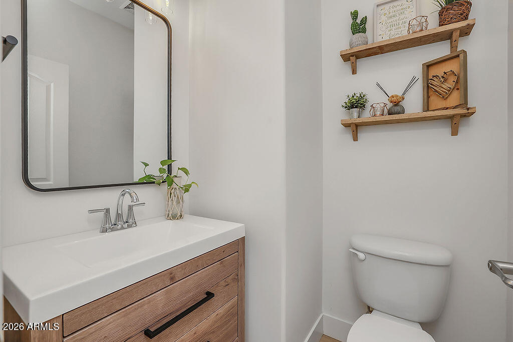 3116 East Tamarisk Street Gilbert, AZ 85296 - Photo 29 of 35 a bathroom with a toilet sink and mirror