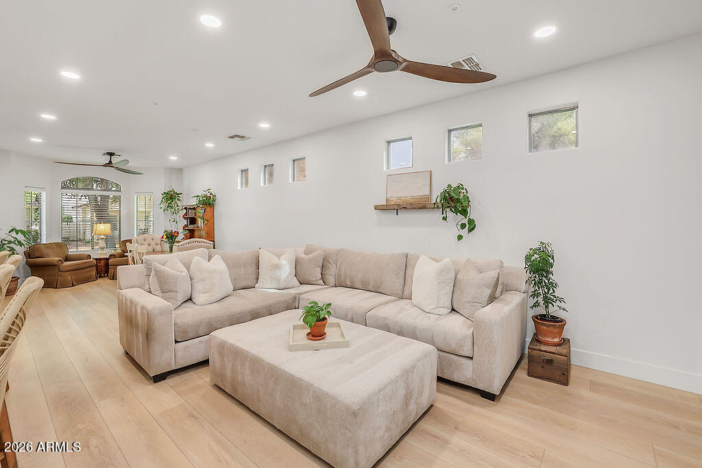 3116 East Tamarisk Street Gilbert, AZ 85296 - Photo 5 of 35 a living room with furniture and a wooden floor