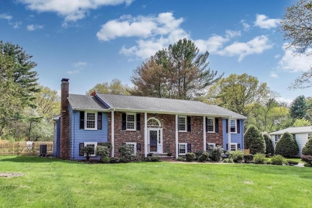 a view of a brick house with a yard