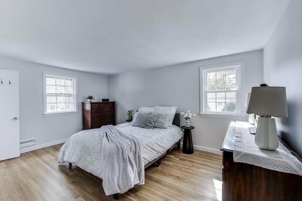 24 Spruce Drive Westwood, MA 02090 - Photo 12 of 32 a bedroom with a bed and wooden floor