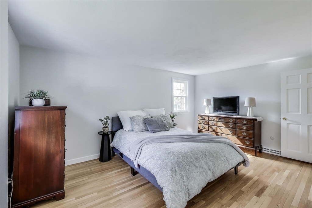 24 Spruce Drive Westwood, MA 02090 - Photo 13 of 32 a bedroom with a bed and wooden floor