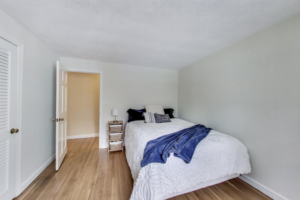 24 Spruce Drive Westwood, MA 02090 - Photo 17 of 32 a bed sitting in a bedroom next to a bathroom