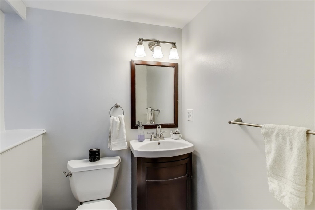 24 Spruce Drive Westwood, MA 02090 - Photo 24 of 32 a bathroom with a toilet sink and mirror