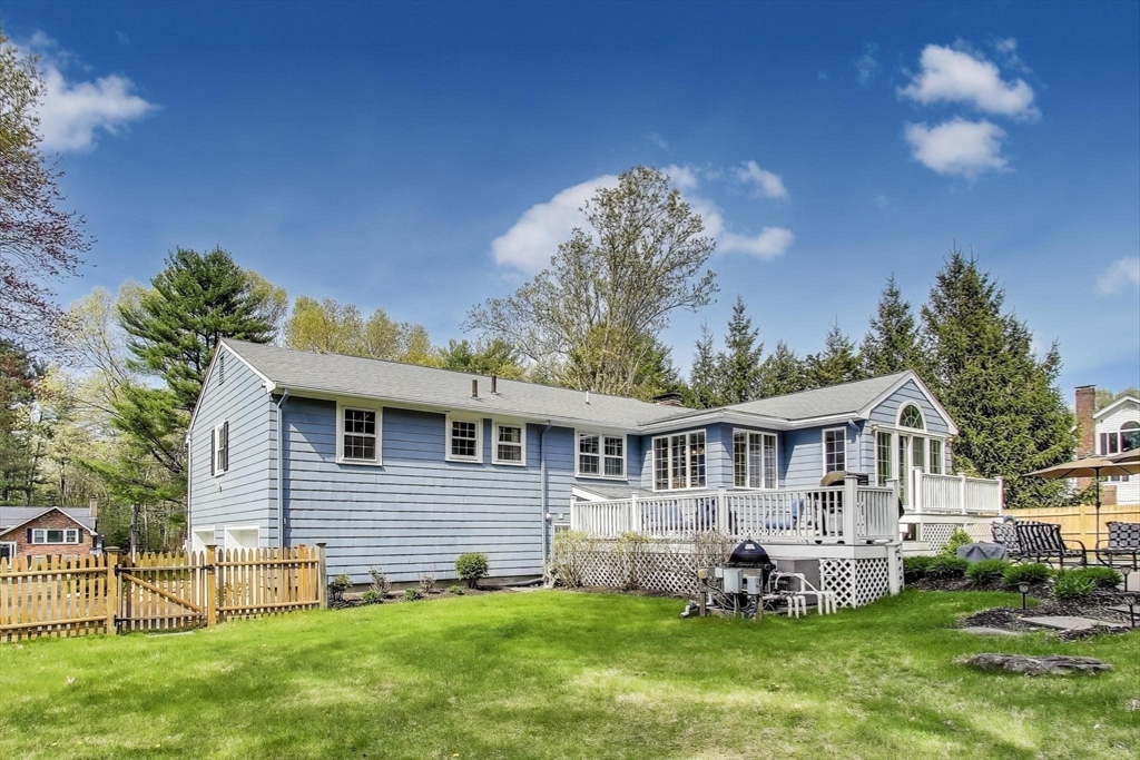24 Spruce Drive Westwood, MA 02090 - Photo 27 of 32 a front view of a house with a yard table and chairs