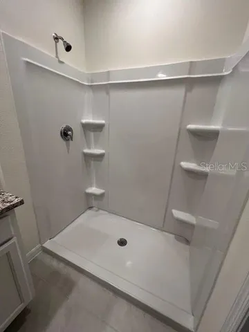 a bathroom with a sink and shower