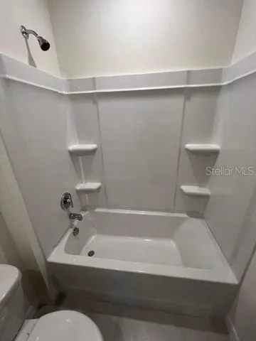 a bathroom with a bathtub and shower