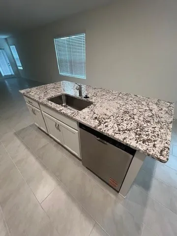 a living room with granite countertop furniture and a fireplace