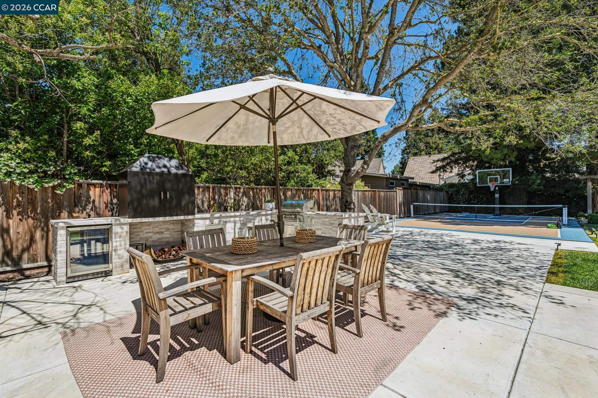 2941 Roundhill Road Alamo, CA 94507 - Photo 66 of 83 a patio table and chairs under an umbrella
