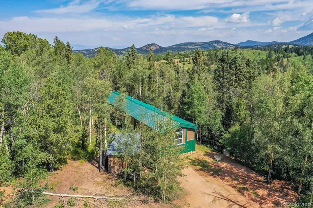 a view of a house with a yard and garage