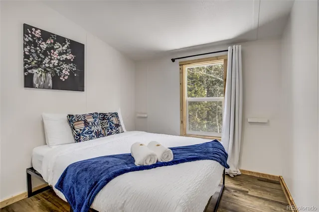 a bedroom with a bed and a window