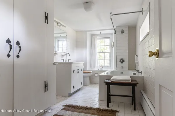 a bathroom with a sink a mirror and a bathtub