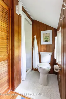 a bathroom with a toilet and a shower