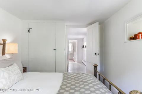 a bedroom with a bed and a lamp