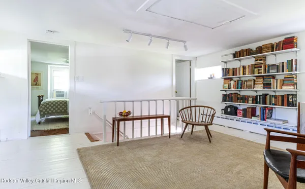 a bedroom with furniture and a book shelf