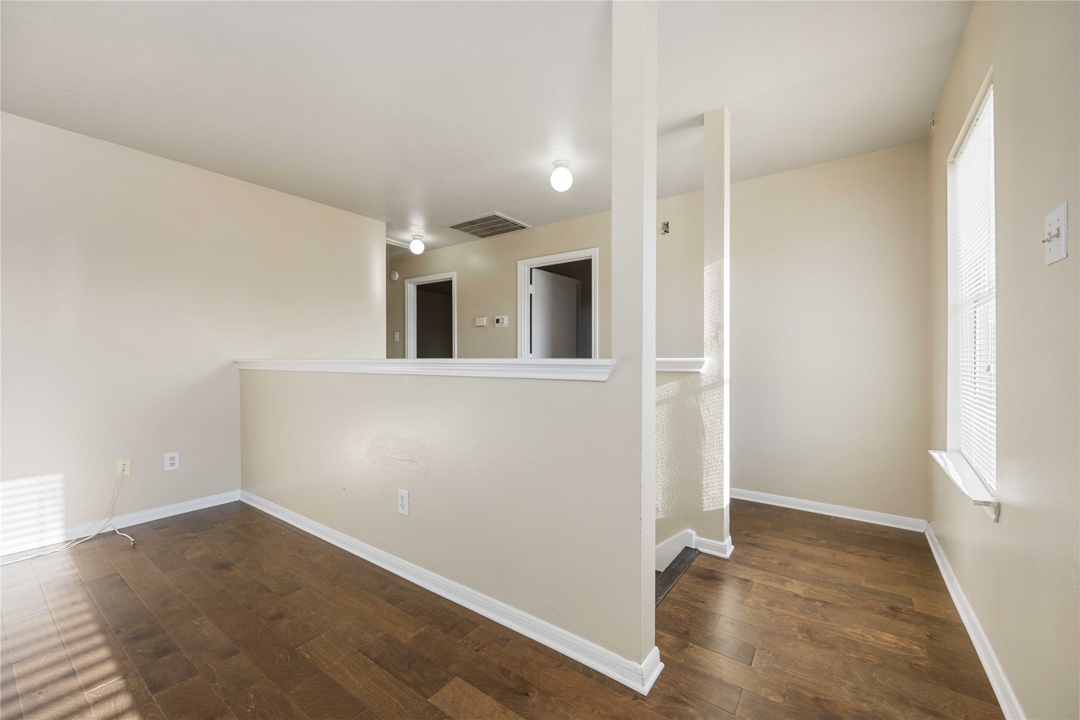 4806 Cotton Ridge Trail Houston, TX 77053 - Photo 16 of 25 an empty room with wooden floor and windows