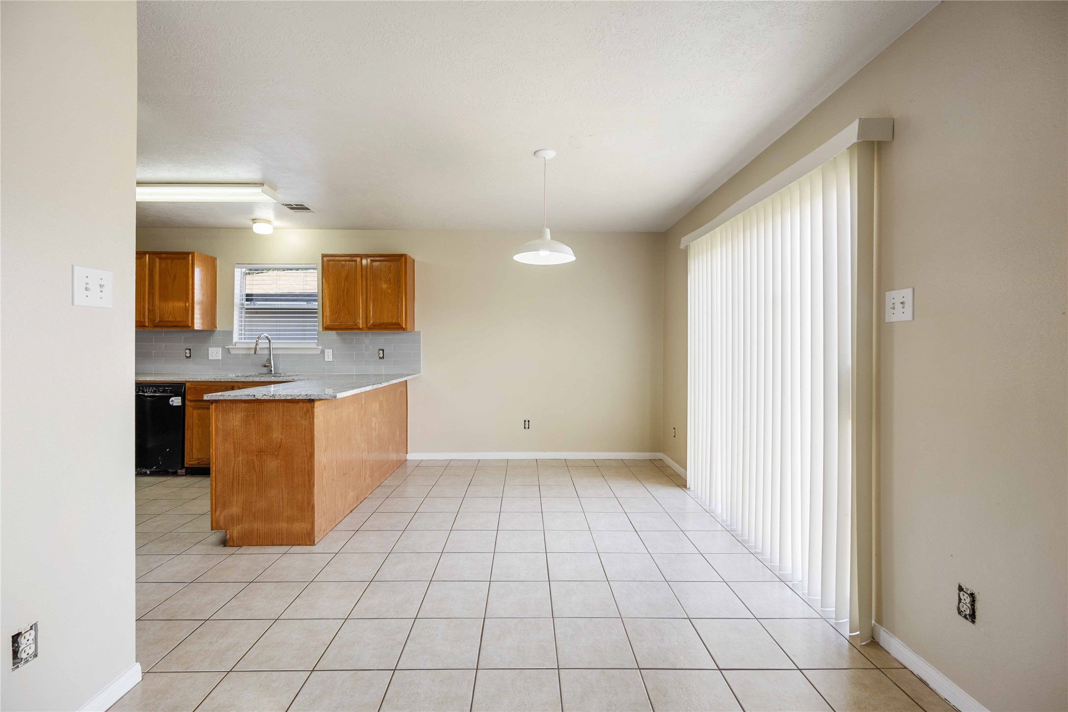 4806 Cotton Ridge Trail Houston, TX 77053 - Photo 10 of 25 a view of a kitchen with kitchen island granite countertop a sink a counter top space and cabinets