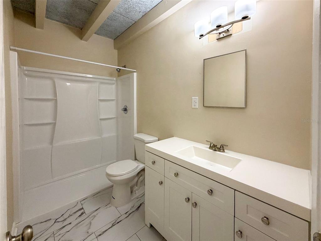 219 Northwest 3rd Avenue, Unit B Gainesville, FL 32601 - Photo 16 of 20 a bathroom with a sink a toilet and shower