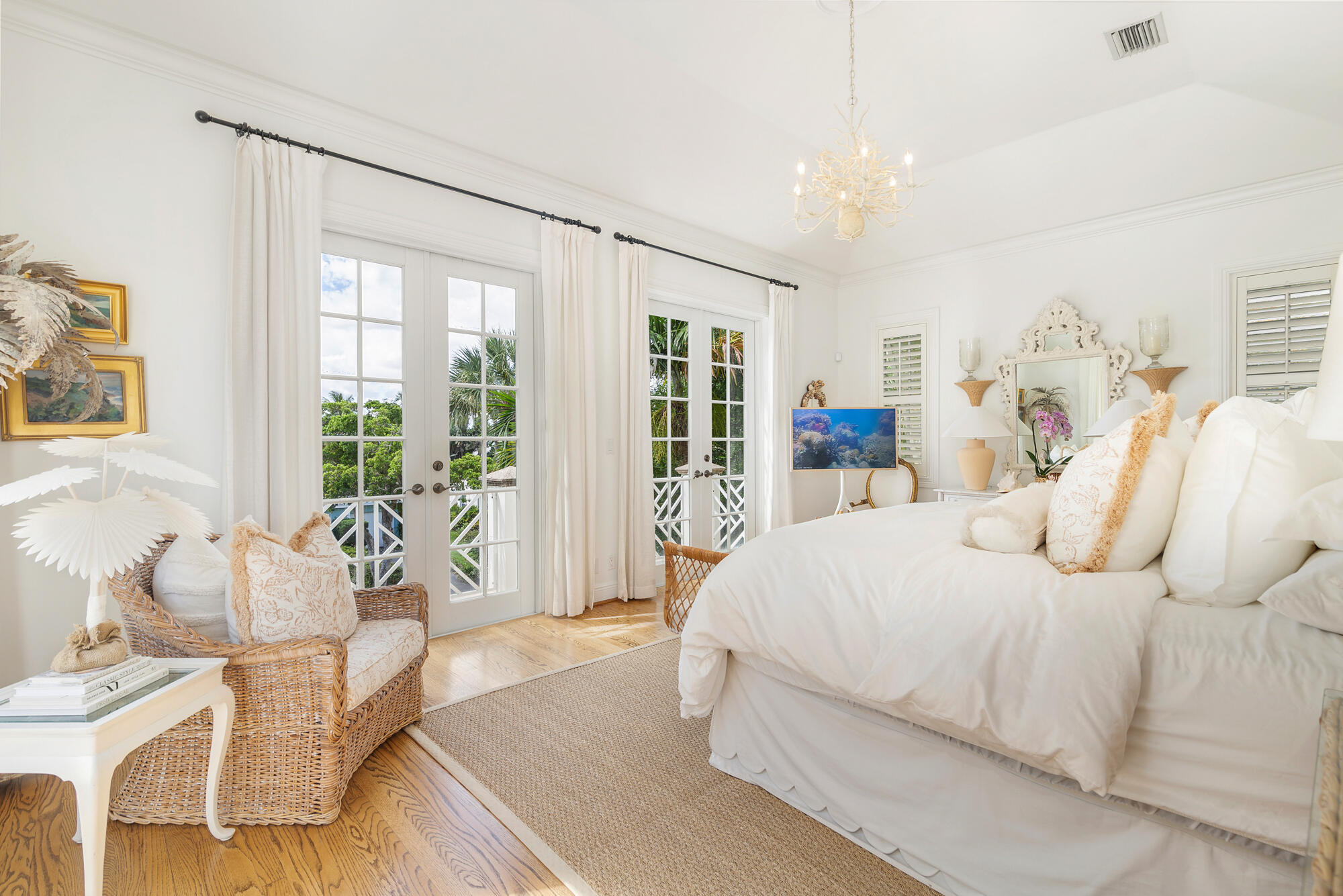 119 Alpine Road West Palm Beach, FL 33405 - Photo 15 of 30 a bedroom with a large bed and a chandelier