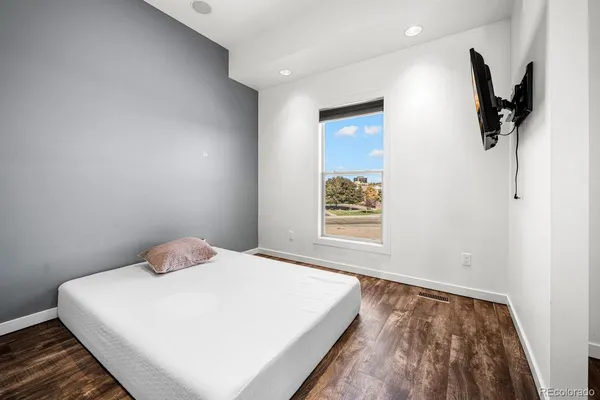 a bedroom with a large bed and a window