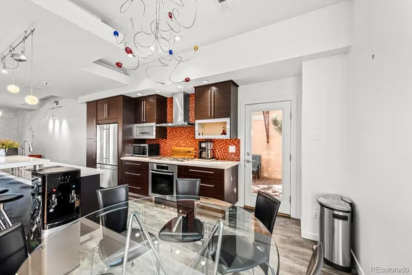 a view of a dining room with furniture and chandelier